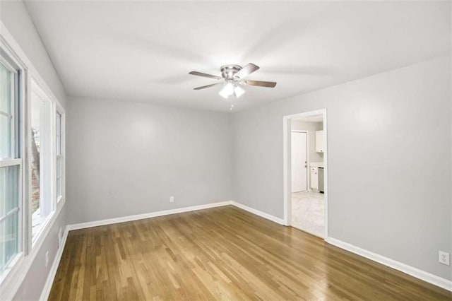 unfurnished room with hardwood / wood-style floors and ceiling fan