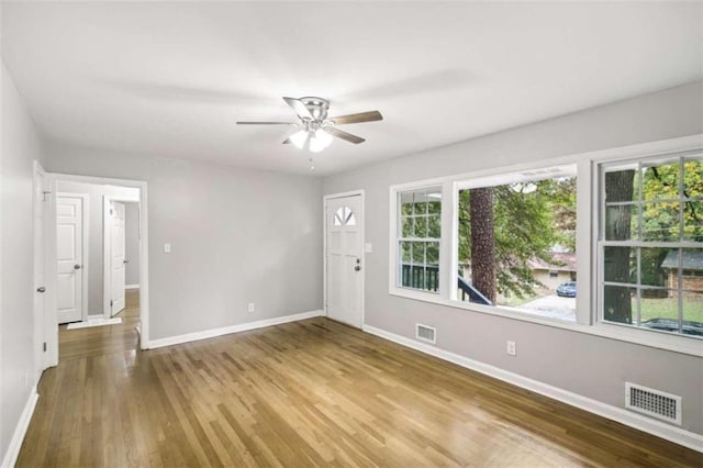 unfurnished room with ceiling fan and hardwood / wood-style floors