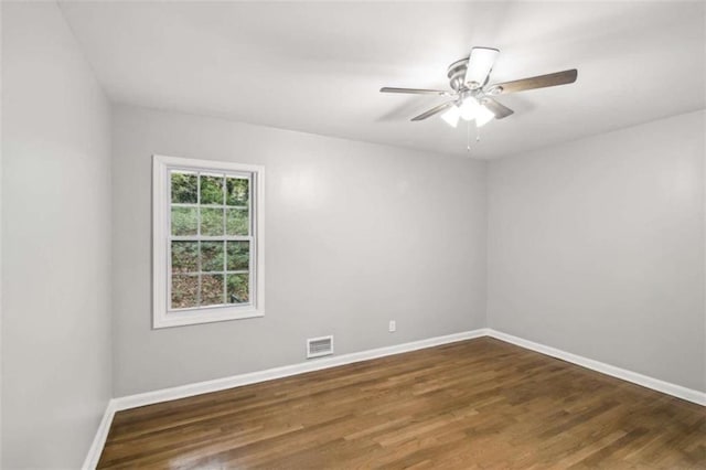 unfurnished room with ceiling fan and dark hardwood / wood-style floors