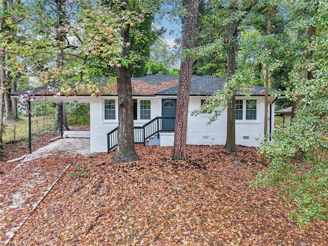 back of property featuring a carport