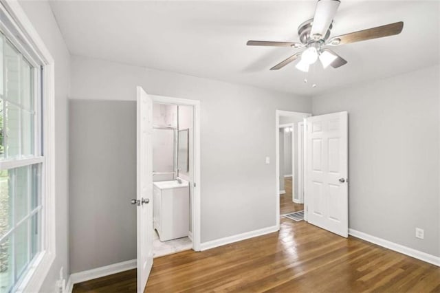 unfurnished bedroom with ceiling fan and dark hardwood / wood-style floors