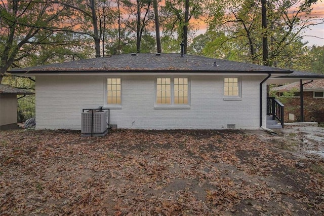 back house at dusk with cooling unit