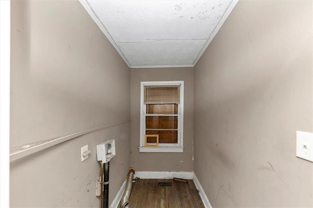 laundry room featuring hardwood / wood-style floors and crown molding