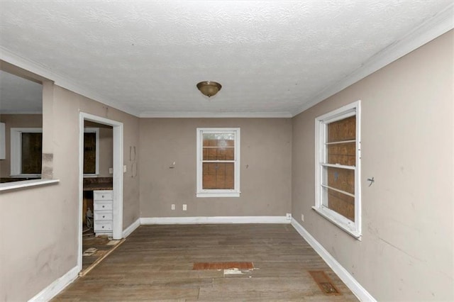 unfurnished dining area featuring ornamental molding, a textured ceiling, and dark hardwood / wood-style flooring