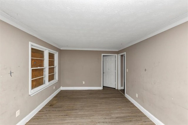 unfurnished room with hardwood / wood-style floors, crown molding, and a textured ceiling