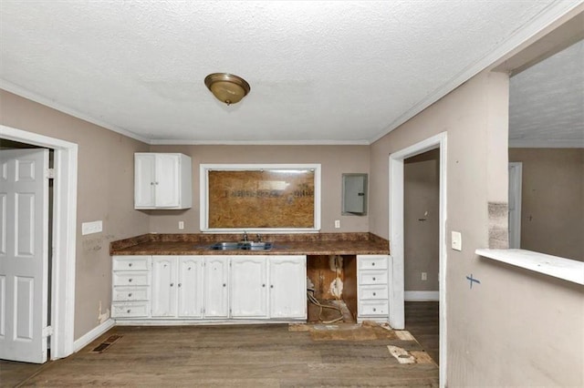 kitchen with dark hardwood / wood-style flooring, sink, white cabinets, and a textured ceiling