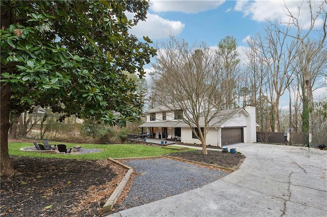 view of front of home with a garage and a front lawn