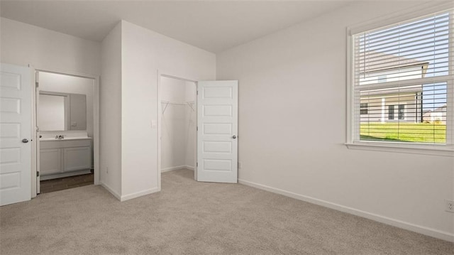 2939 Champions Way, Loganville, GA 30052 - unfurnished bedroom with light colored carpet, multiple windows, a closet, and connected bathroom