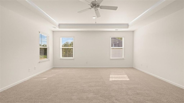 2939 Champions Way, Loganville, GA 30052 - spare room featuring a tray ceiling, carpet, and ceiling fan