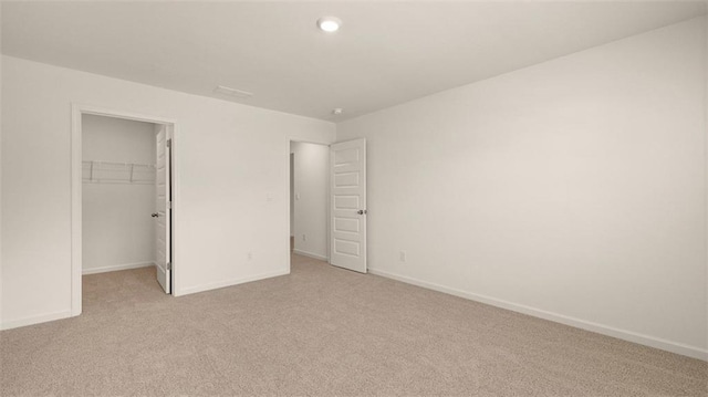 2939 Champions Way, Loganville, GA 30052 - unfurnished bedroom with light carpet, a spacious closet, a closet, and recessed lighting