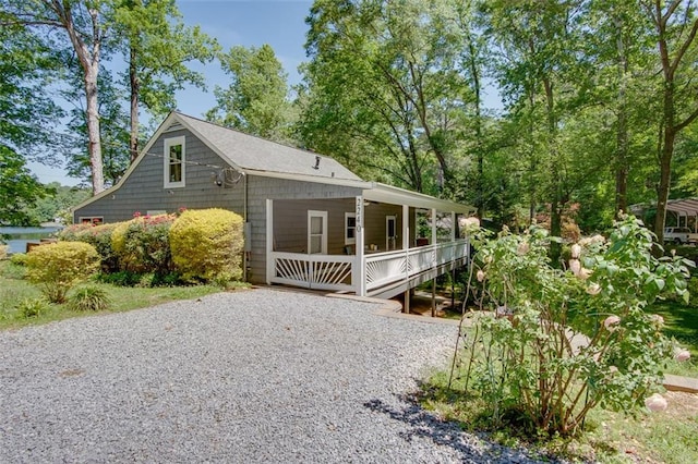 view of side of home featuring covered porch