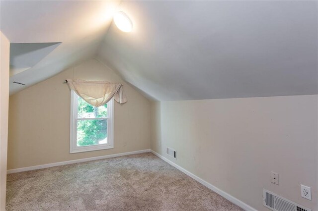 additional living space featuring carpet flooring, lofted ceiling, and baseboards