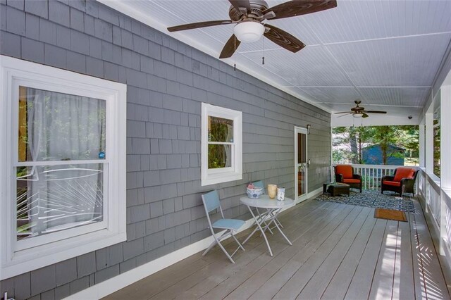 wooden deck featuring ceiling fan and covered porch
