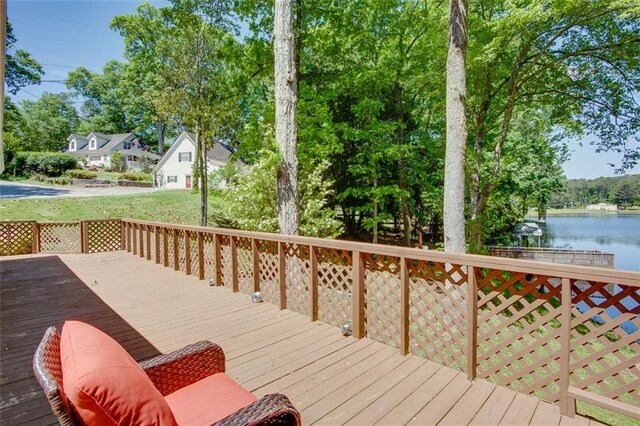 deck with a water view and view of scattered trees