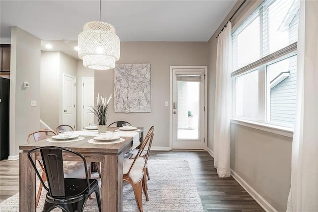 dining area featuring baseboards and wood finished floors