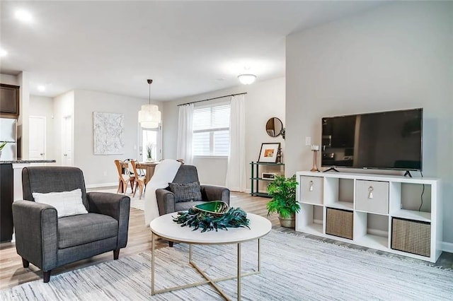 living room featuring baseboards and light wood finished floors