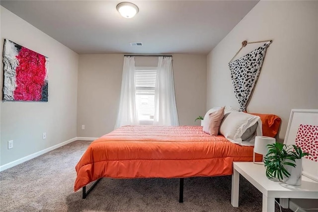 carpeted bedroom featuring visible vents and baseboards