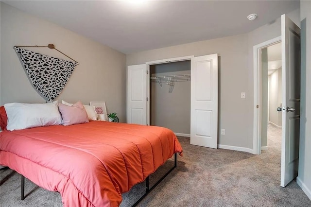 carpeted bedroom with a closet and baseboards