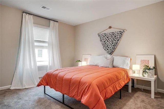 bedroom with visible vents, baseboards, and carpet