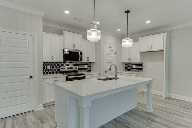 kitchen with white cabinets, decorative light fixtures, sink, and stainless steel appliances