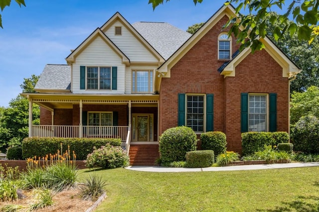 3175 Lake Seminole Pl, Buford, GA 30519 - view of front facade with brick siding, a porch, a front lawn, and roof with shingles