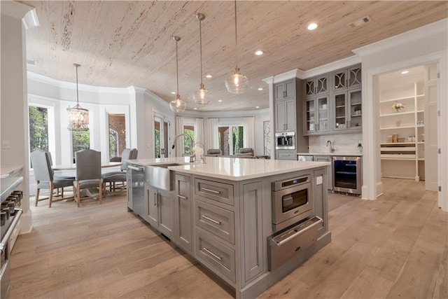 kitchen with gray cabinetry, a sink, beverage cooler, a warming drawer, and wood ceiling