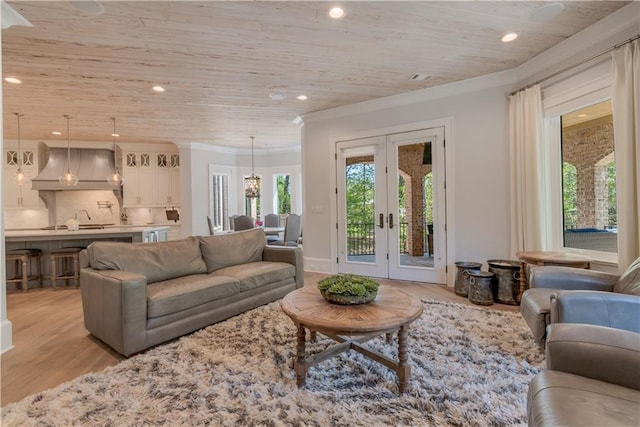 living area featuring french doors, wood ceiling, light wood-style flooring, recessed lighting, and crown molding