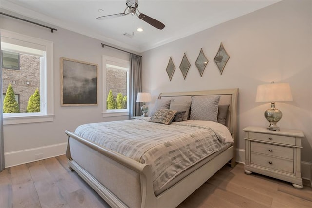 bedroom featuring multiple windows, baseboards, light wood-style floors, recessed lighting, and crown molding