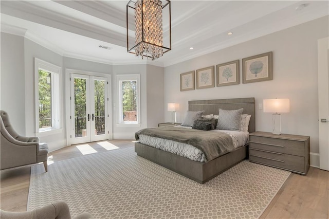 bedroom with ornamental molding, french doors, light wood-type flooring, access to outside, and a chandelier