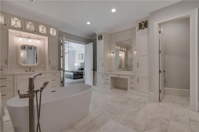 full bathroom with crown molding, recessed lighting, a freestanding tub, marble finish flooring, and vanity
