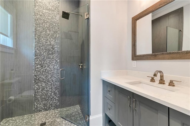 bathroom with a stall shower and vanity