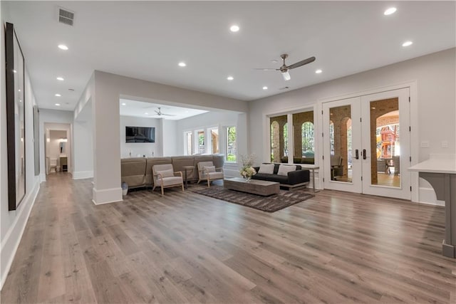 living room with ceiling fan, wood finished floors, recessed lighting, french doors, and baseboards