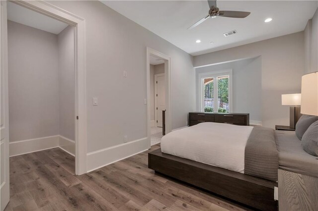 bedroom featuring wood finished floors, baseboards, recessed lighting, and a ceiling fan