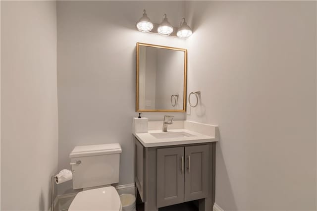 half bath featuring toilet and vanity
