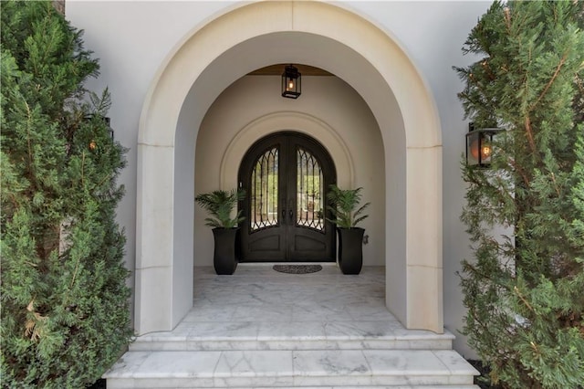 property entrance featuring french doors and stucco siding