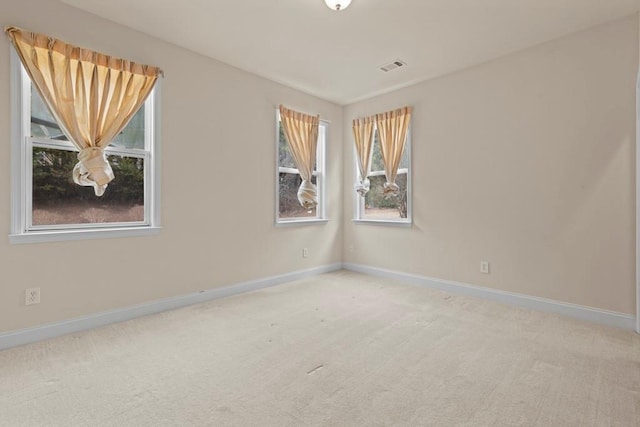 carpeted empty room with baseboards and visible vents