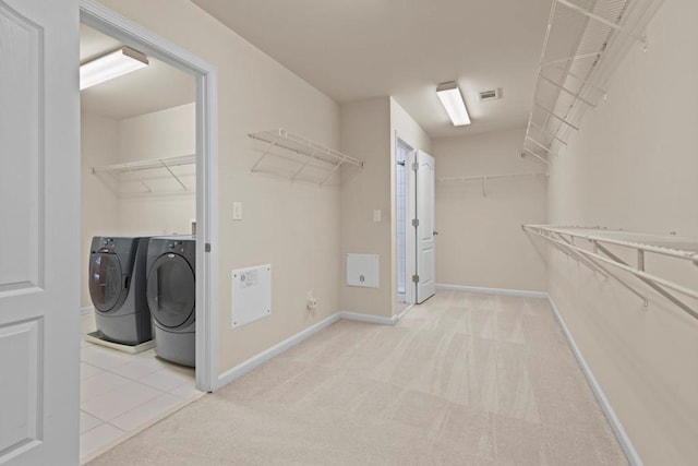 laundry room featuring carpet, visible vents, washer and clothes dryer, and baseboards