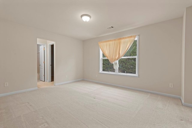 carpeted empty room featuring visible vents and baseboards