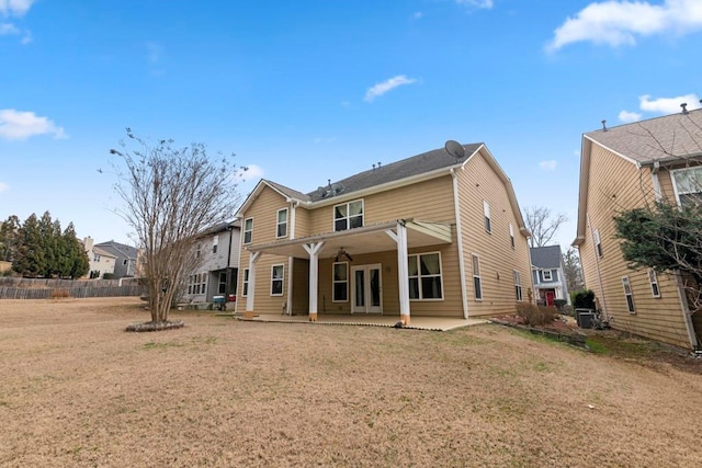 back of house with a patio area and a yard