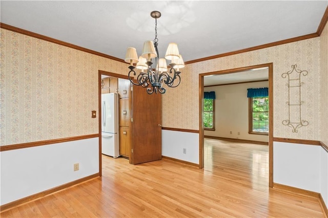 3802 SW Knights Bridge Rd SW, Lilburn, GA 30047 - spare room with light wood-type flooring, a chandelier, wallpapered walls, ornamental molding, and baseboards
