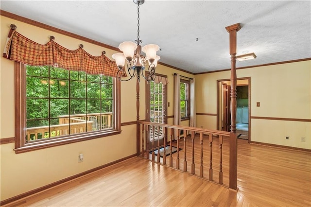 3802 SW Knights Bridge Rd SW, Lilburn, GA 30047 - unfurnished room featuring wood finished floors, ornamental molding, a chandelier, and baseboards