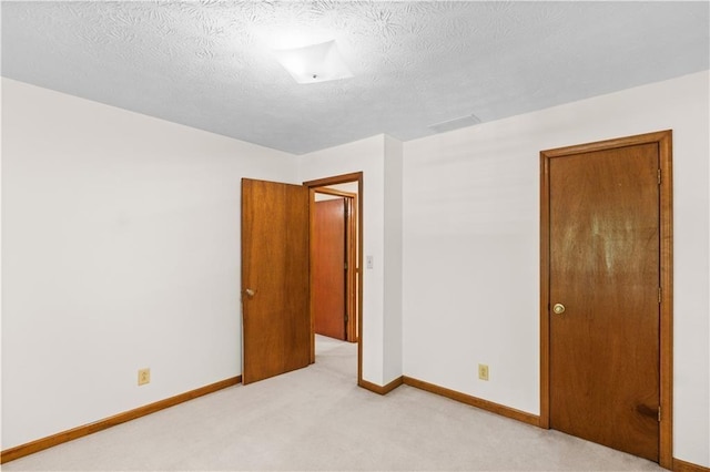 3802 SW Knights Bridge Rd SW, Lilburn, GA 30047 - unfurnished room featuring light colored carpet, baseboards, and a textured ceiling