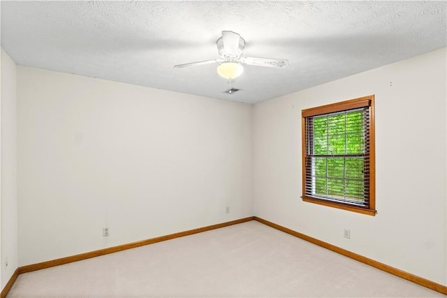 3802 SW Knights Bridge Rd SW, Lilburn, GA 30047 - empty room with light colored carpet, baseboards, a ceiling fan, and a textured ceiling