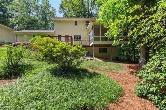 3802 SW Knights Bridge Rd SW, Lilburn, GA 30047 - rear view of property featuring a sunroom, a wooden deck, and a lawn