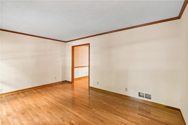 3802 SW Knights Bridge Rd SW, Lilburn, GA 30047 - spare room featuring light wood-style floors, crown molding, and baseboards