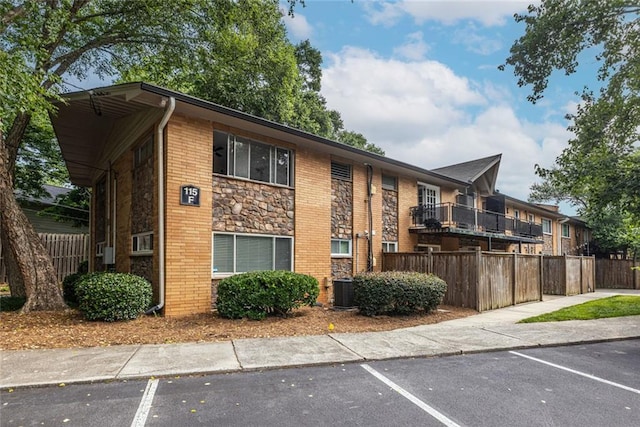 115 Biscayne Dr NW Unit F10, Atlanta, GA 30309 - view of building exterior featuring uncovered parking and cooling unit