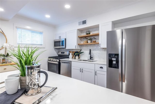 115 Biscayne Dr NW Unit F10, Atlanta, GA 30309 - kitchen featuring stainless steel appliances, a sink, open shelves, light countertops, and backsplash
