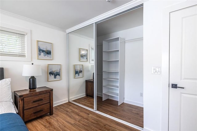 115 Biscayne Dr NW Unit F10, Atlanta, GA 30309 - bedroom featuring wood finished floors, crown molding, baseboards, and a closet
