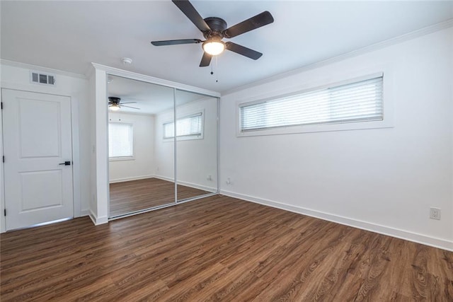 115 Biscayne Dr NW Unit F10, Atlanta, GA 30309 - unfurnished bedroom featuring crown molding, baseboards, wood finished floors, a ceiling fan, and a closet