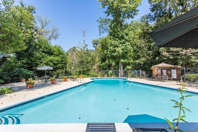 115 Biscayne Dr NW Unit F10, Atlanta, GA 30309 - community pool with view of scattered trees and a patio